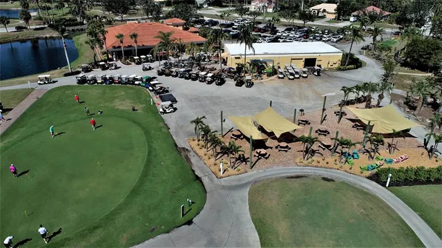 an aerial view of a house with a garden and houses