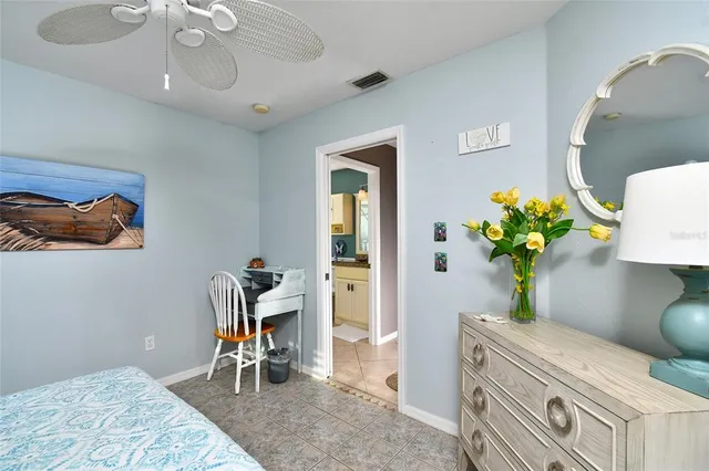 a living room with furniture flowerpot and a chandelier