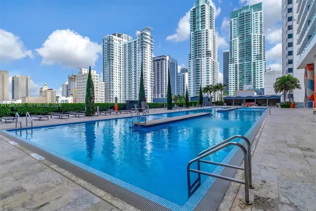 a view of swimming pool with outdoor seating and city view