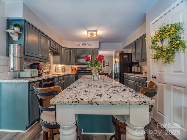 a kitchen with a table and chairs in it