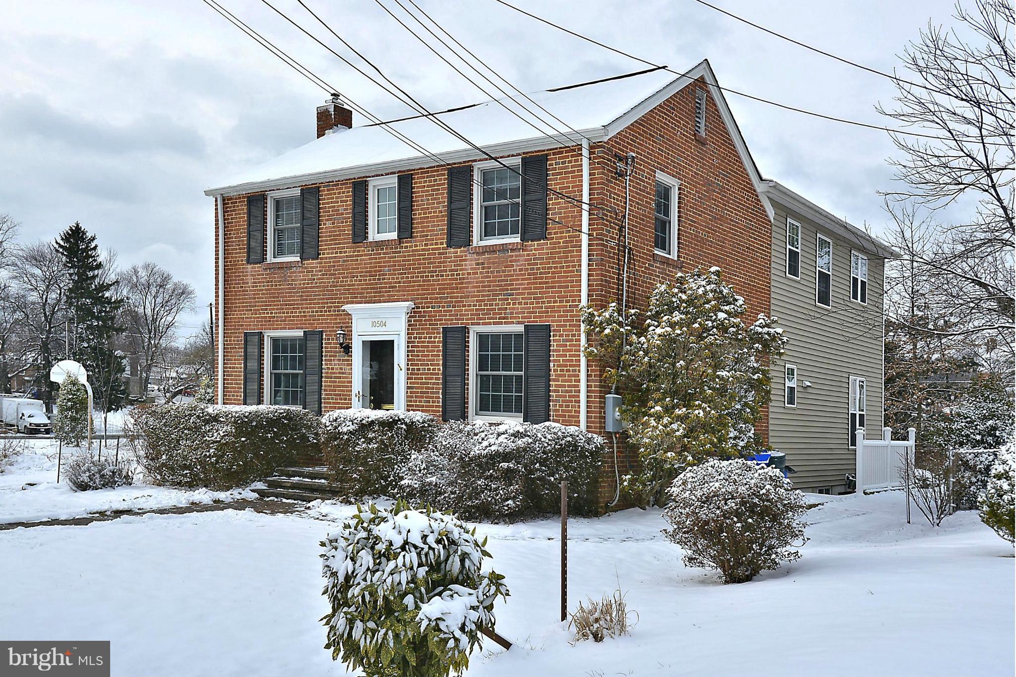 10504 Amherst Avenue Silver Spring, MD 20902 - Photo 1 of 30 a front view of a house with a yard and potted plants