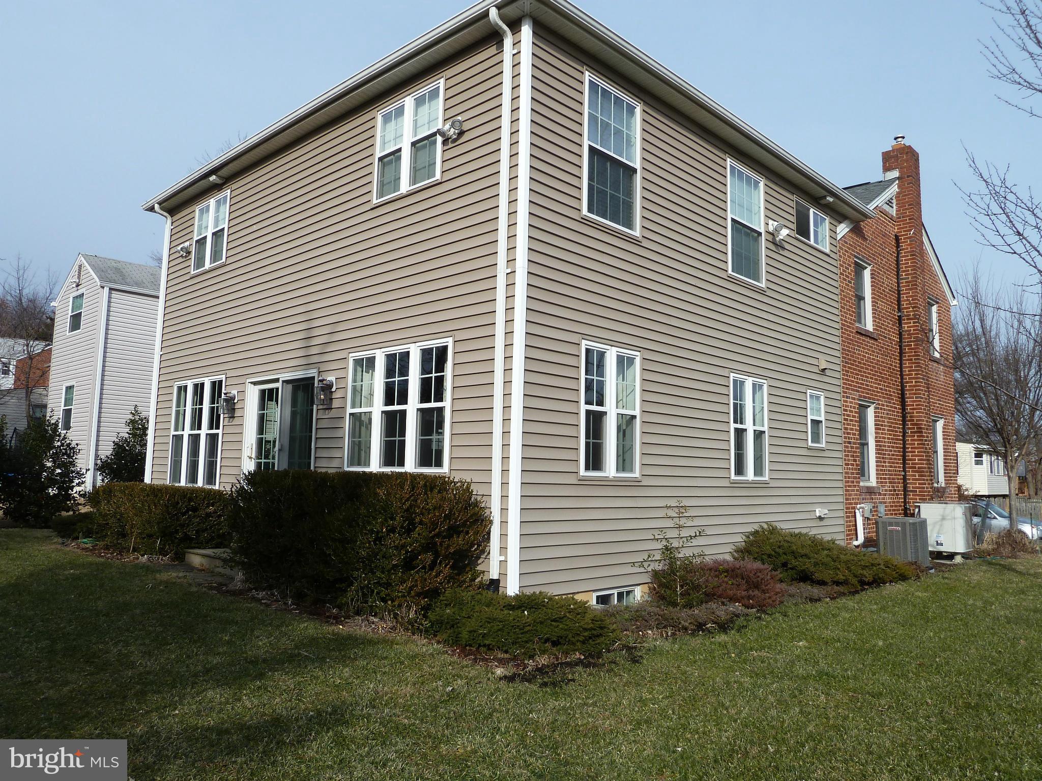 10504 Amherst Avenue Silver Spring, MD 20902 - Photo 2 of 30 a front view of a house with a yard and garden