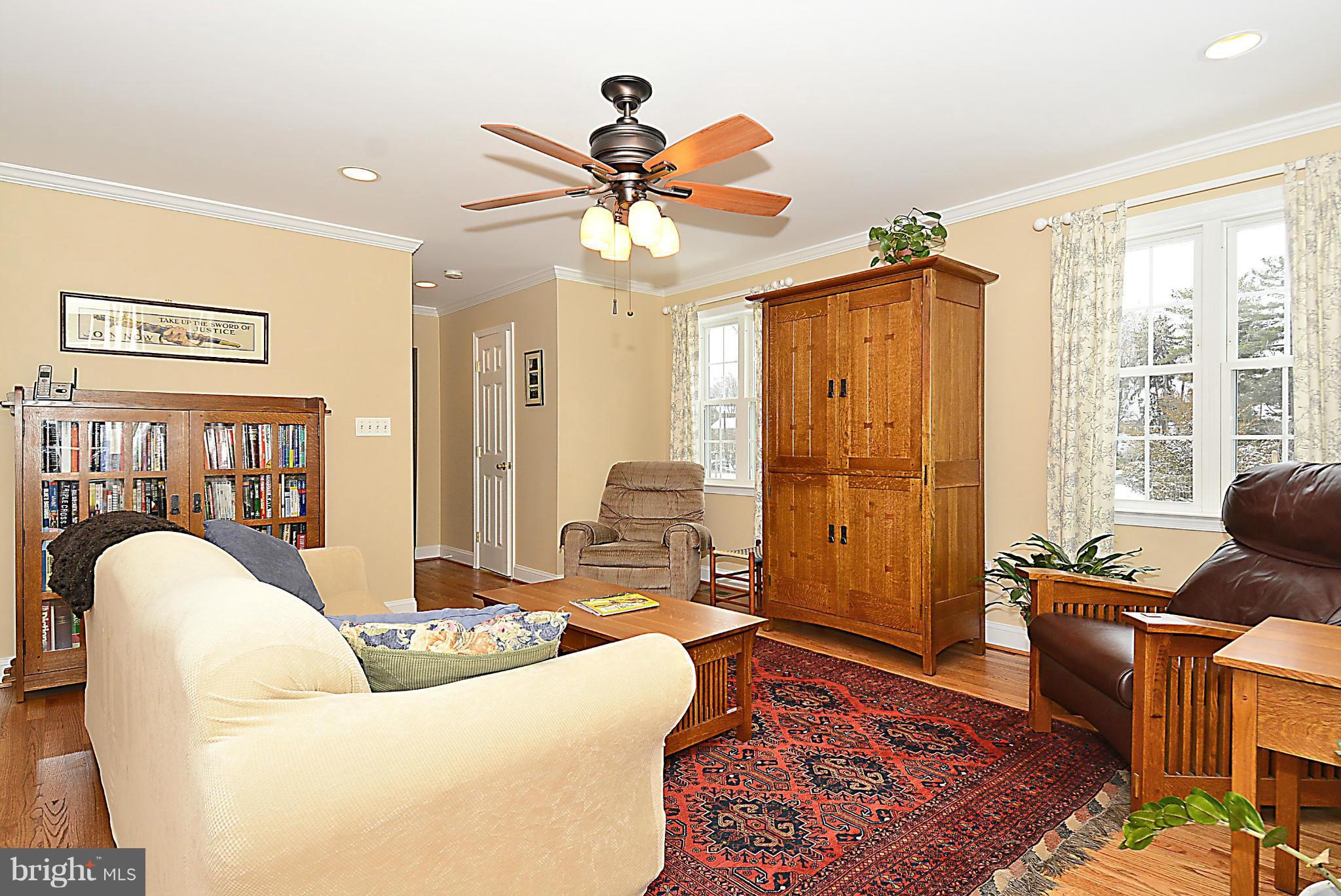 10504 Amherst Avenue Silver Spring, MD 20902 - Photo 13 of 30 a living room with furniture a chandelier and a rug
