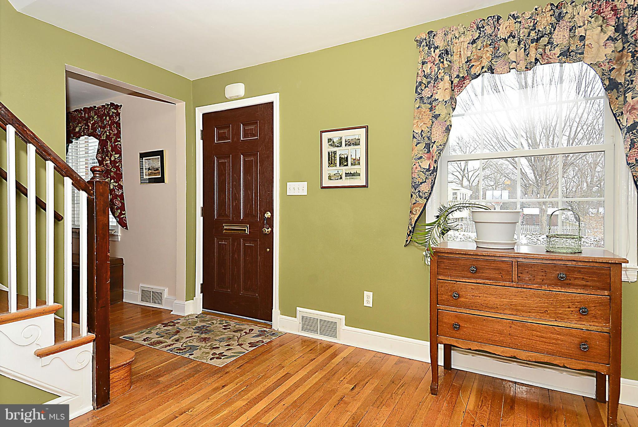 10504 Amherst Avenue Silver Spring, MD 20902 - Photo 17 of 30 a bedroom with a bed and wooden floor