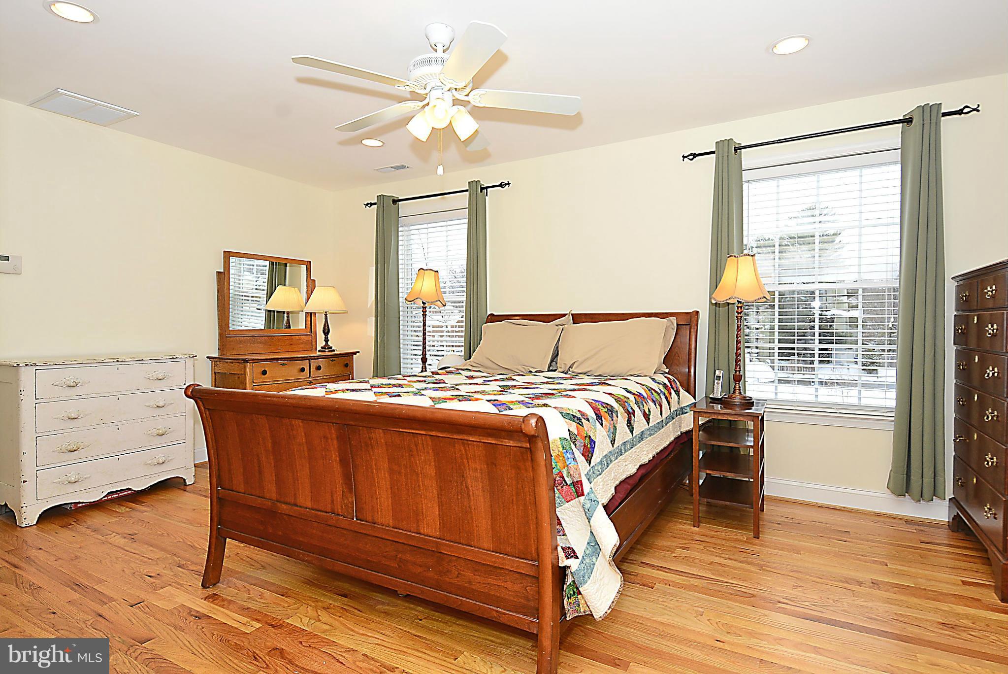 10504 Amherst Avenue Silver Spring, MD 20902 - Photo 23 of 30 a spacious bedroom with a bed and wooden floor