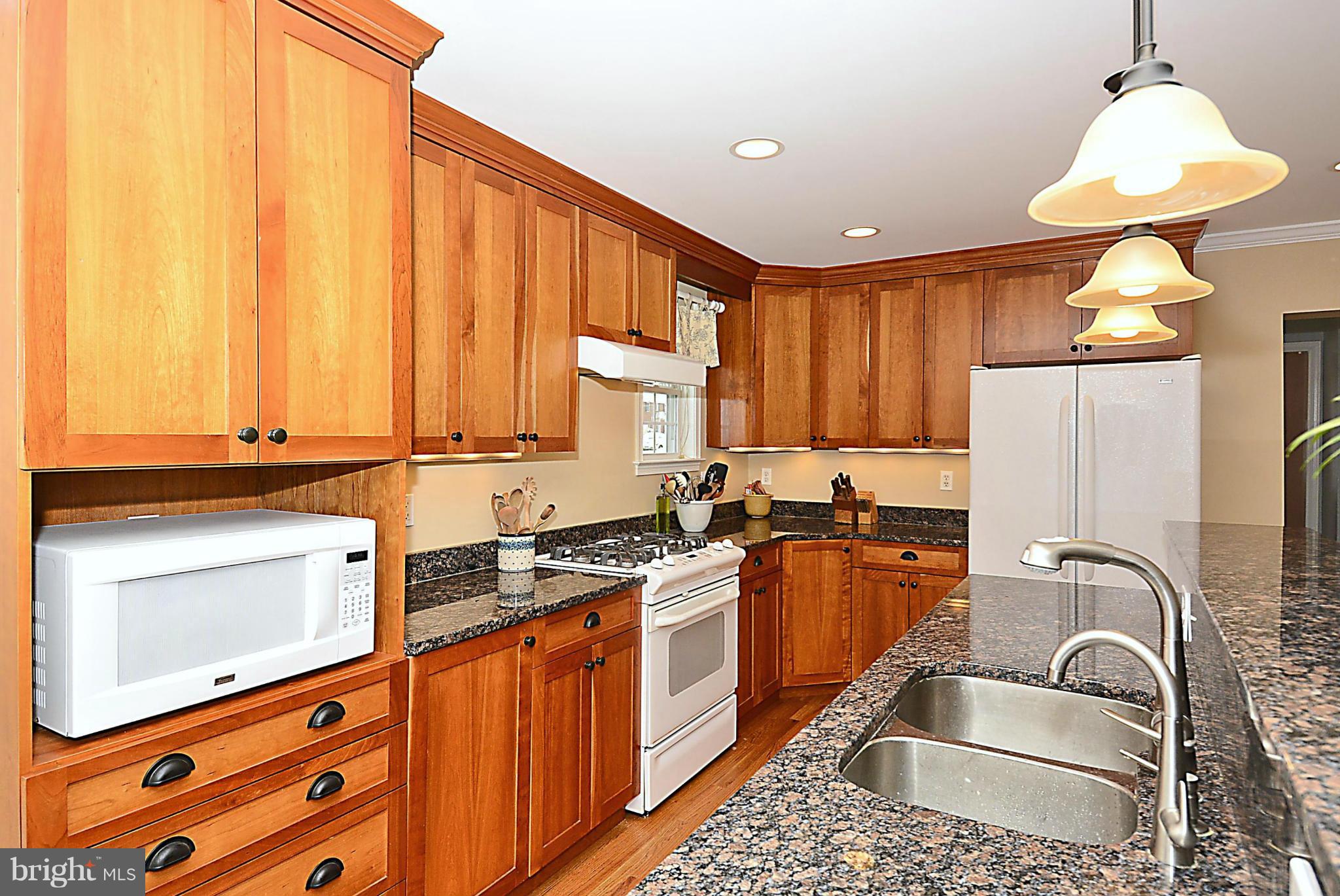 10504 Amherst Avenue Silver Spring, MD 20902 - Photo 7 of 30 a kitchen that has a sink cabinets counter space and a window