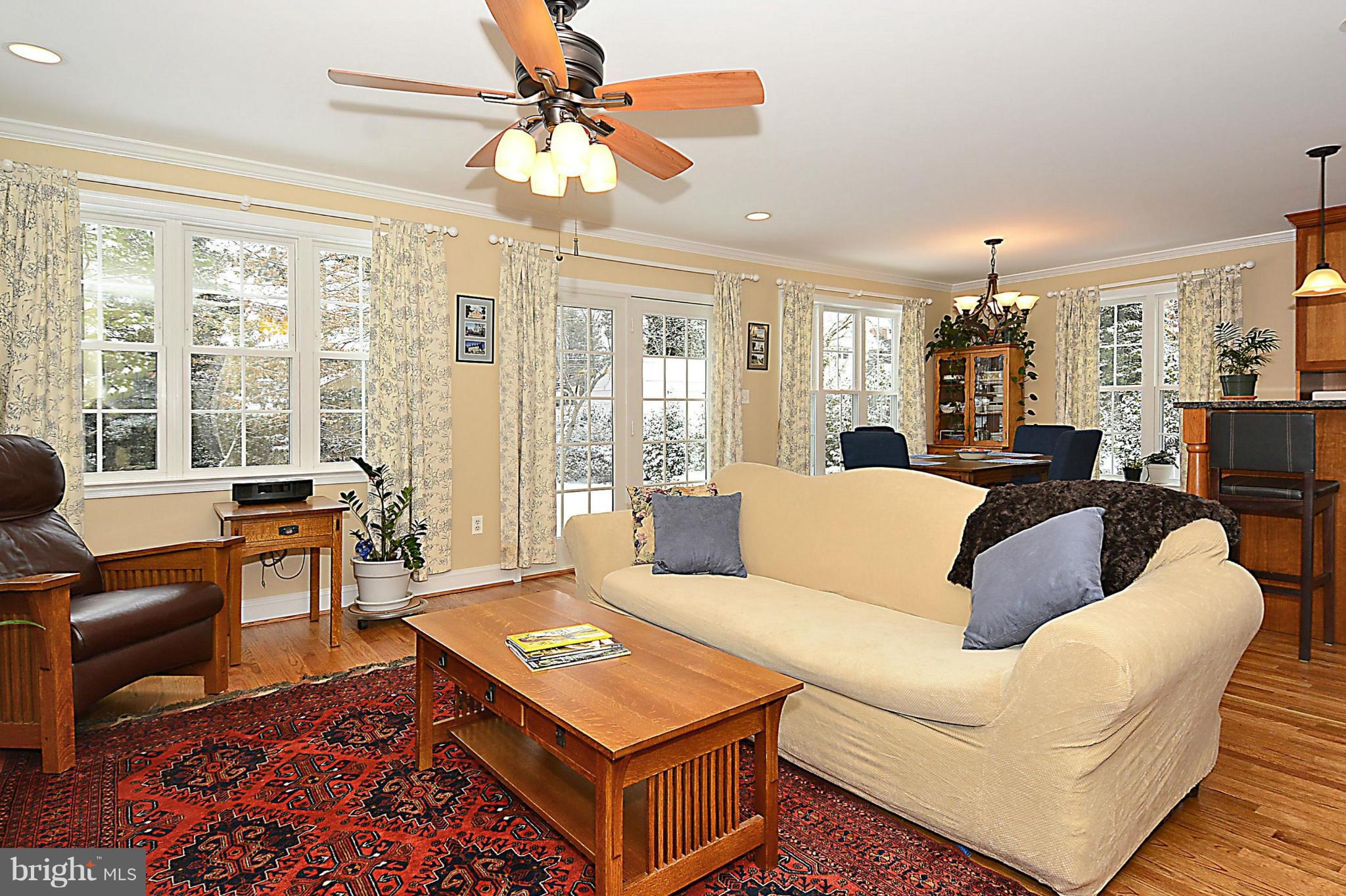 10504 Amherst Avenue Silver Spring, MD 20902 - Photo 10 of 30 a living room with furniture a large window and a chandelier