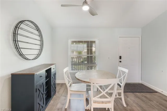 a kitchen with stainless steel appliances granite countertop a sink dishwasher stove and white cabinets with wooden floor