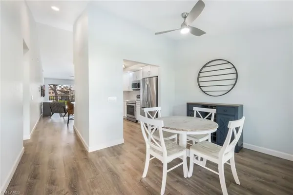 a kitchen with granite countertop white cabinets white stainless steel appliances and a sink