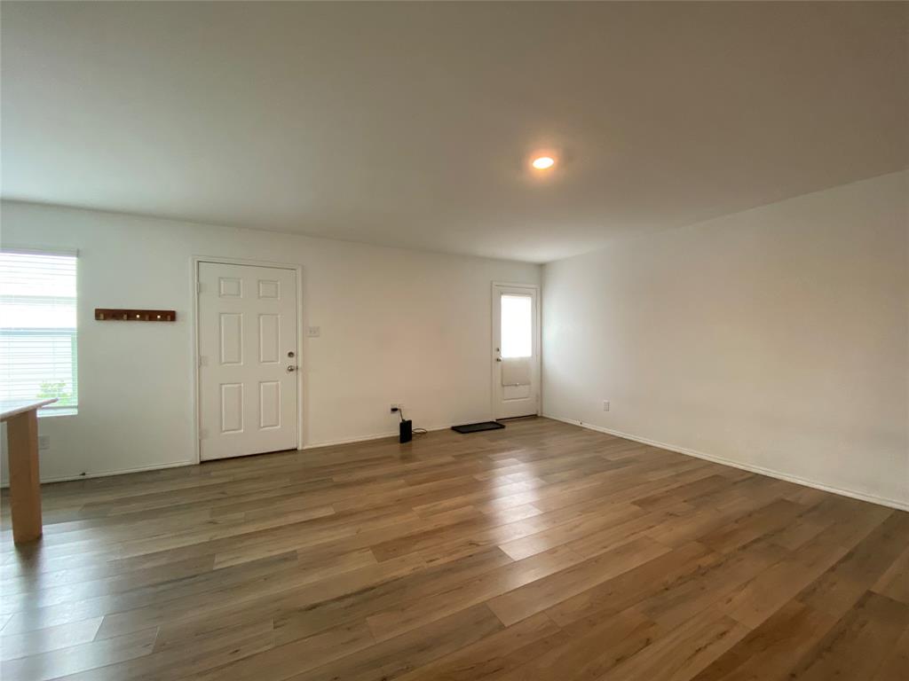 5911 Nyquist Way Forney, TX 75126 - Photo 11 of 38 an empty room with wooden floor and windows