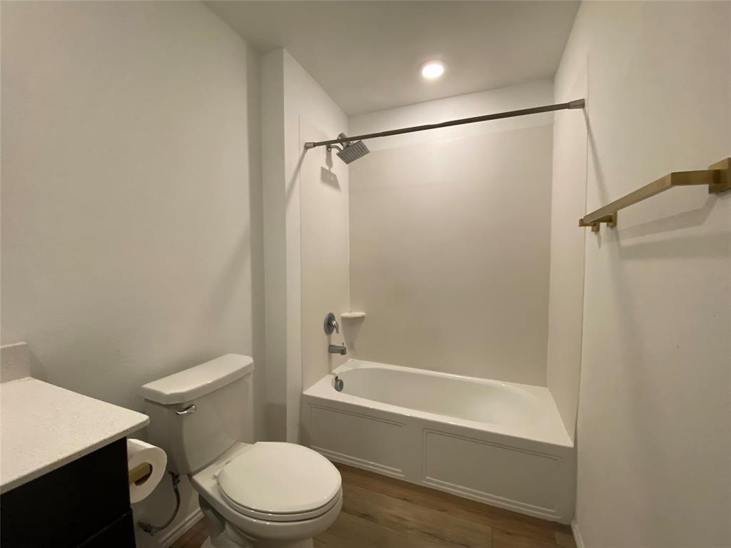 5911 Nyquist Way Forney, TX 75126 - Photo 27 of 38 a white toilet and tub sitting next to a bathroom sink