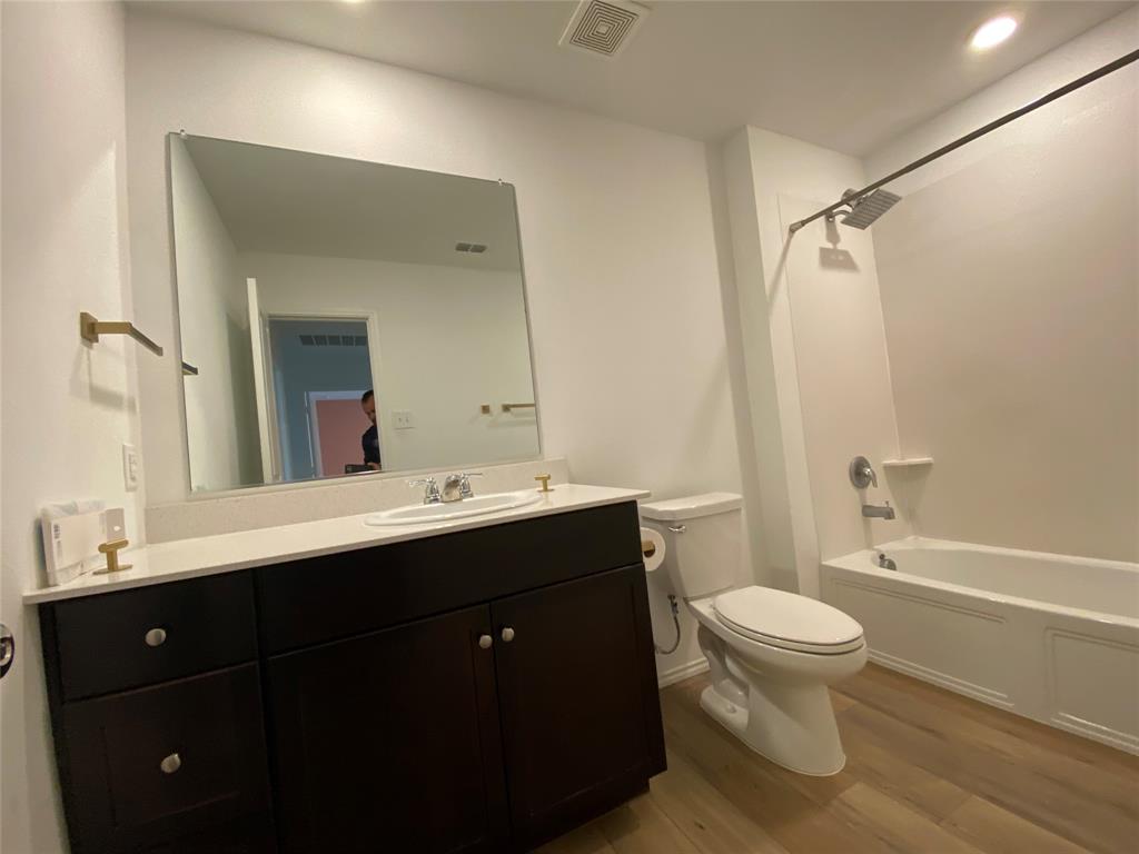 5911 Nyquist Way Forney, TX 75126 - Photo 28 of 38 a bathroom with a sink vanity toilet and shower