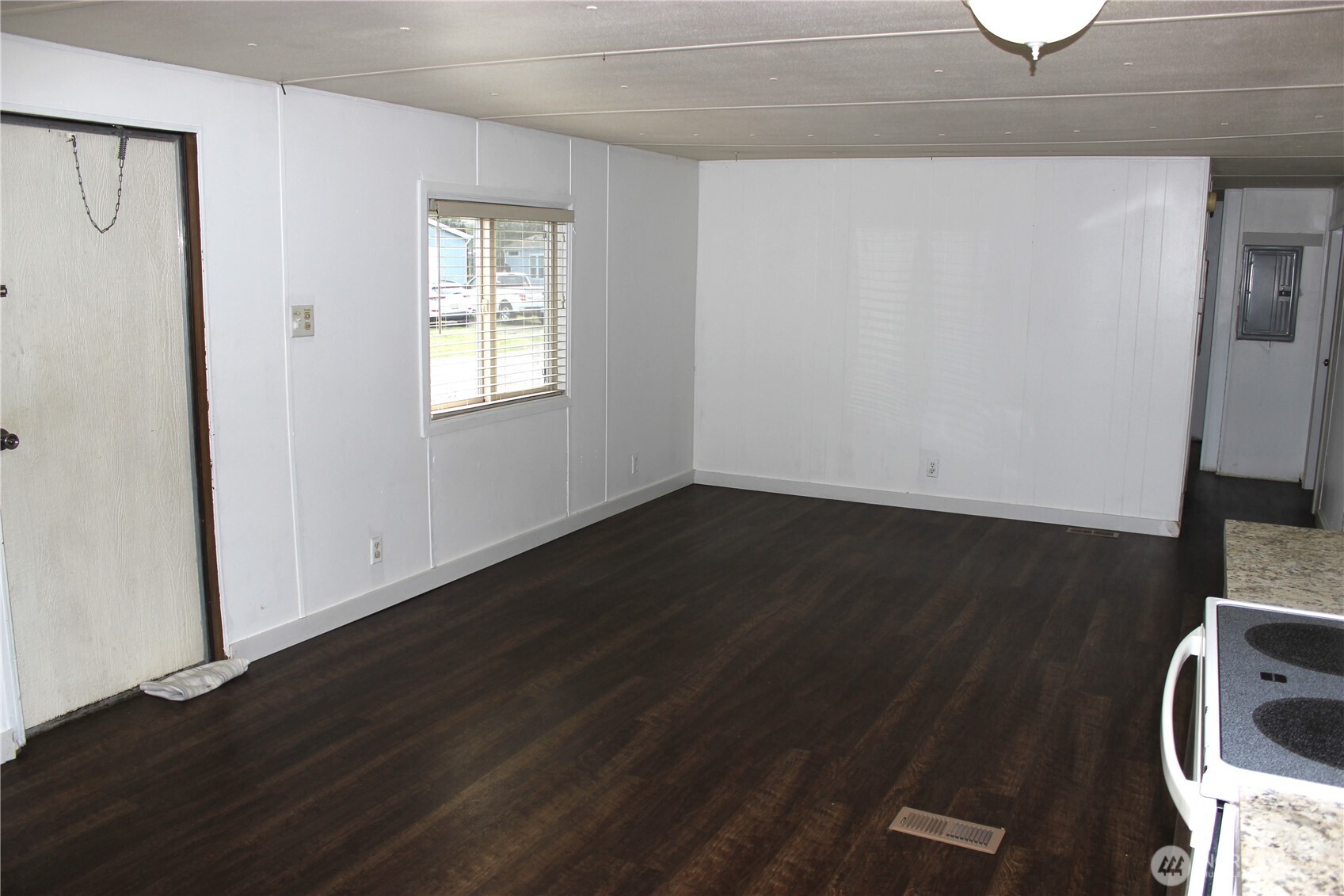 10531 176th Avenue Southwest, Unit 6 Rochester, WA 98579 - Photo 11 of 24 an empty room with wooden floor and windows