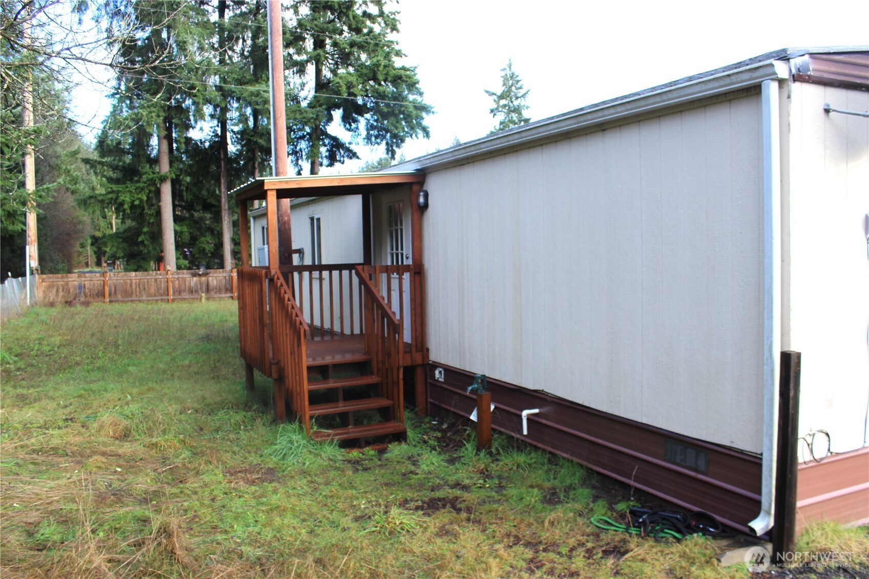 10531 176th Avenue Southwest, Unit 6 Rochester, WA 98579 - Photo 19 of 24 a view of a backyard with a large tree