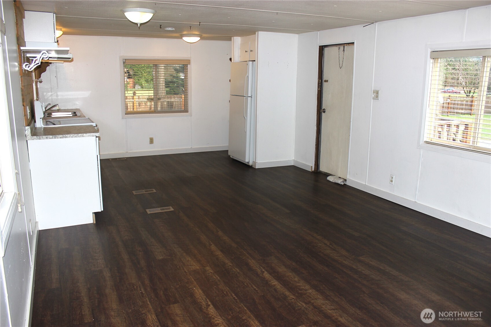 10531 176th Avenue Southwest, Unit 6 Rochester, WA 98579 - Photo 6 of 24 an empty room with wooden floor and windows
