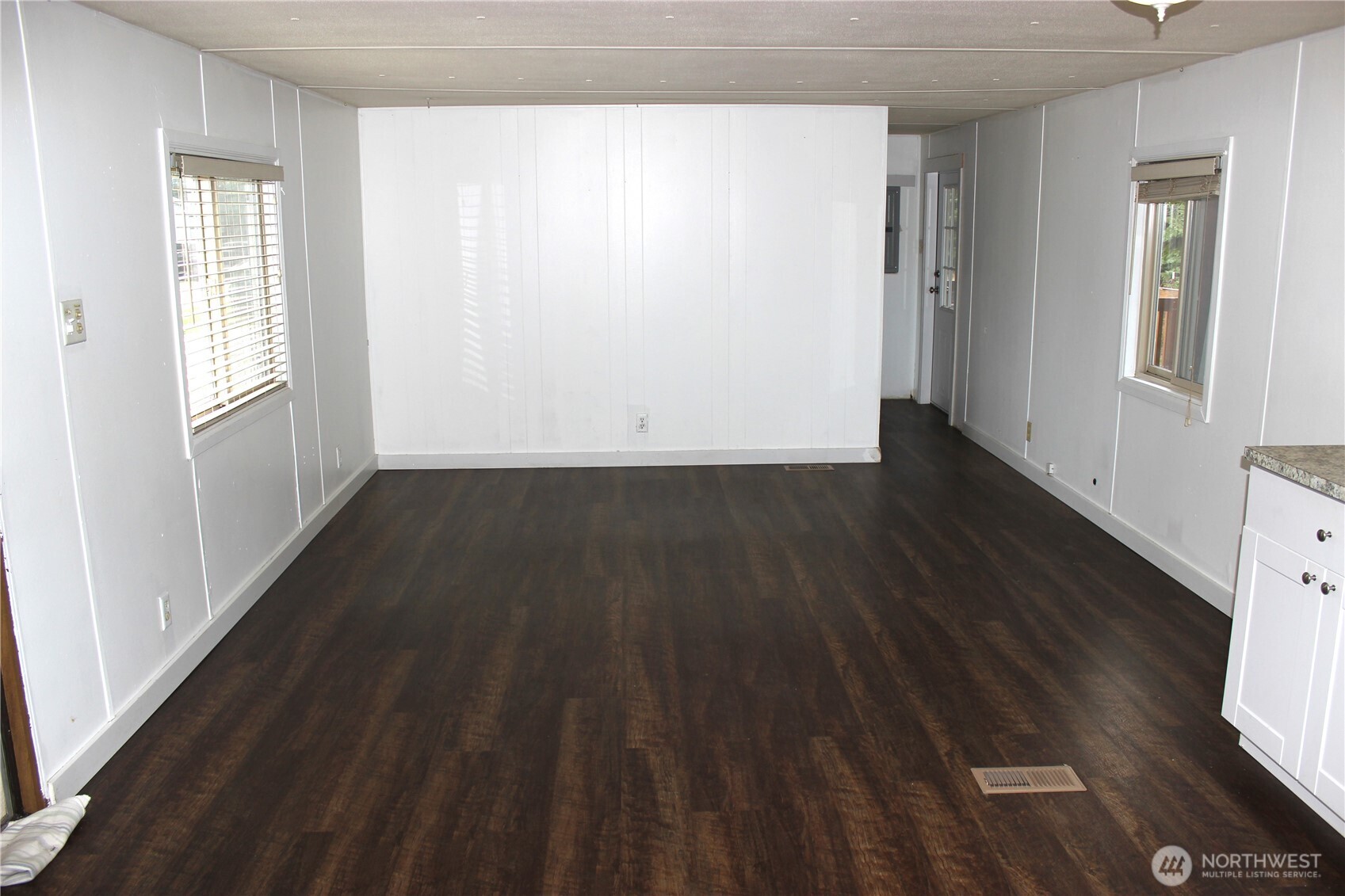 10531 176th Avenue Southwest, Unit 6 Rochester, WA 98579 - Photo 9 of 24 a view of an empty room with wooden floor and a window