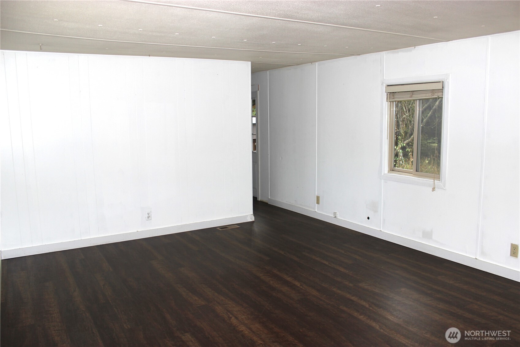 10531 176th Avenue Southwest, Unit 6 Rochester, WA 98579 - Photo 10 of 24 an empty room with wooden floor and windows