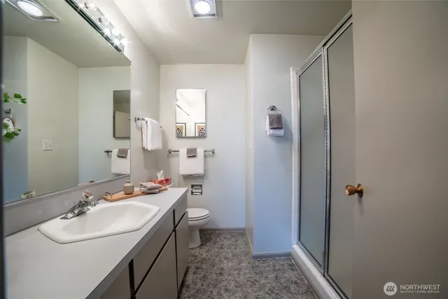 a bathroom with a tub a sink and mirror