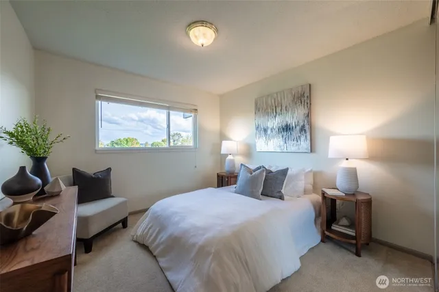 a bed room with a bed mirror and a table