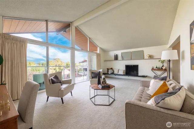 a living room with furniture and a floor to ceiling window
