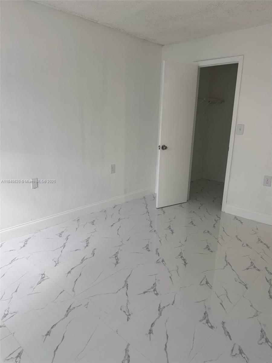 7010 Northwest 179th Street, Unit 105 Hialeah, FL 33015 - Photo 6 of 9 a view of an empty room