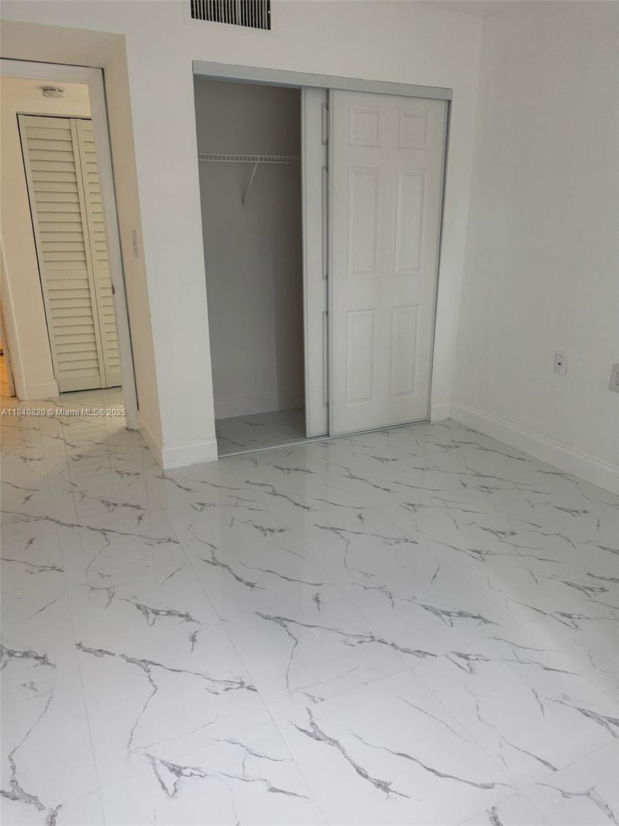 7010 Northwest 179th Street, Unit 105 Hialeah, FL 33015 - Photo 7 of 9 a view of an empty room
