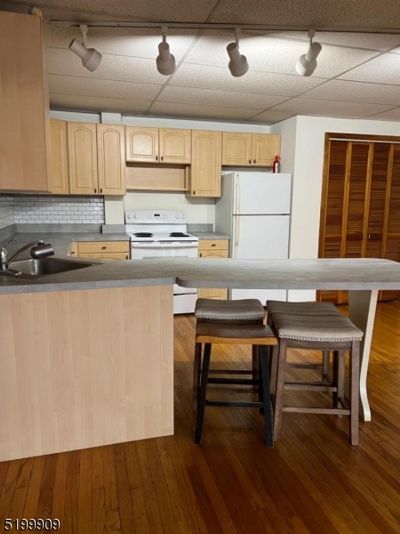 351 Springfield Avenue, Unit 3 Summit, NJ 07901 - Photo 2 of 6 a kitchen with a sink cabinets and wooden floor