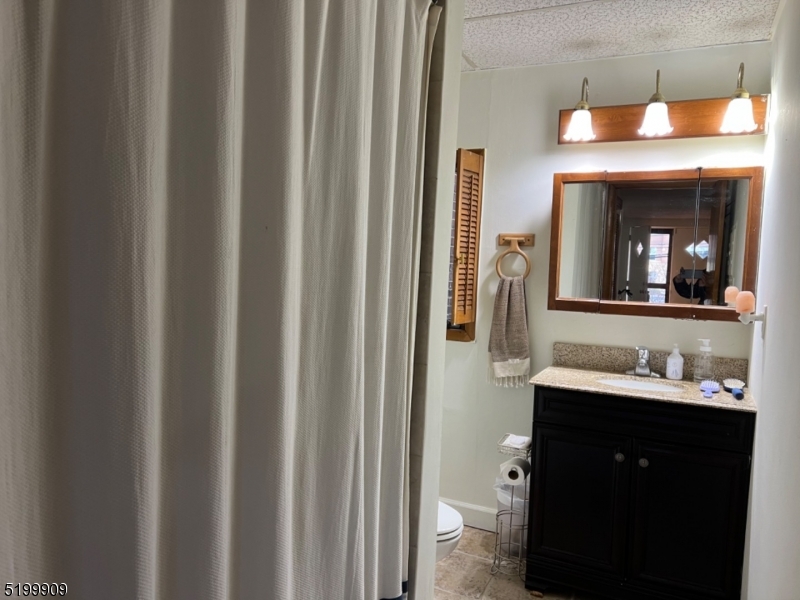 351 Springfield Avenue, Unit 3 Summit, NJ 07901 - Photo 6 of 6 a bathroom with a sink vanity and a mirror