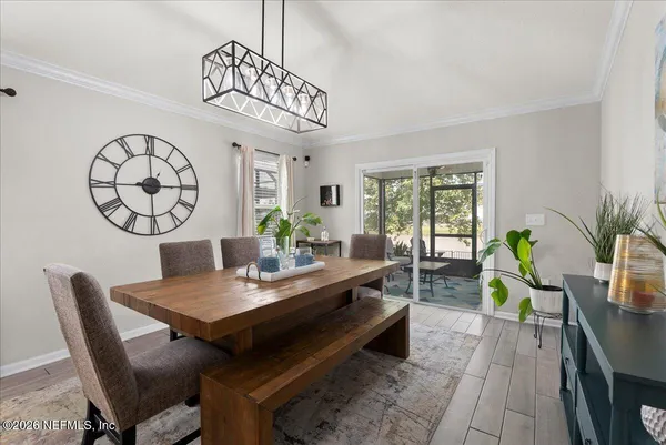a view of a dining room with furniture window and wooden floor