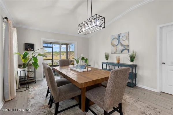 a view of a dining room with furniture and chandelier