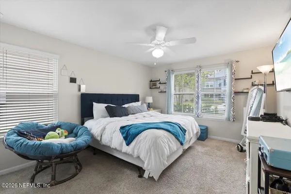 a bed room with a bed and a chair