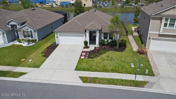 an aerial view of a house with a yard table and chairs