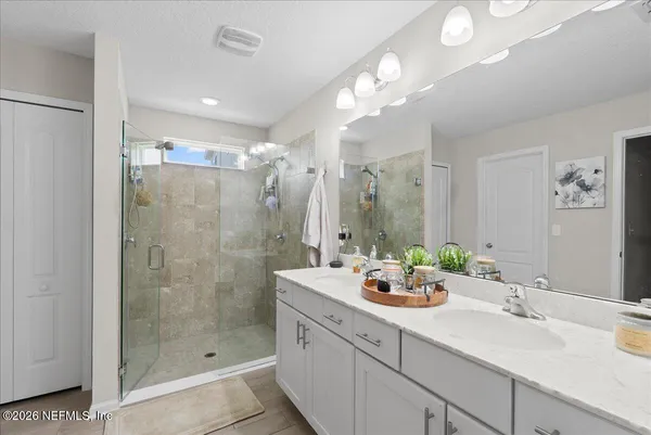 a bathroom with a sink double vanity and shower