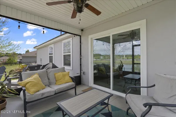 a living room with furniture and a floor to ceiling window