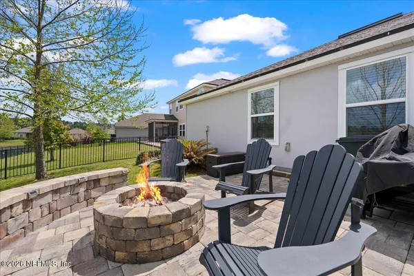 a view of a patio with couches fire pit and a patio