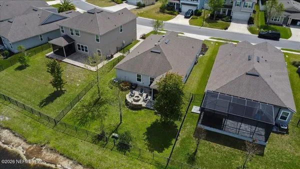 an aerial view of a house with a yard and lake view