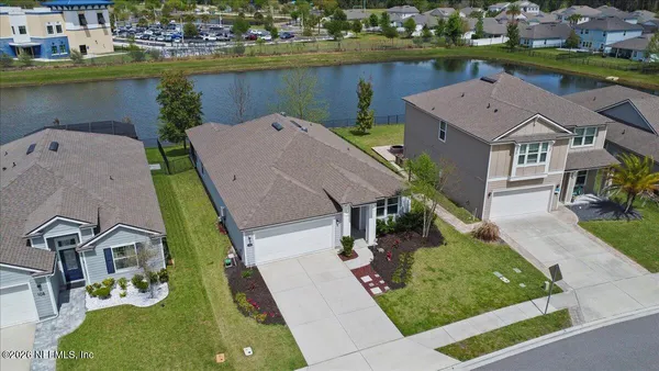 an aerial view of a house with a lake view
