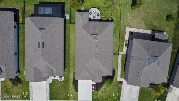 an aerial view of a house with a yard and pool