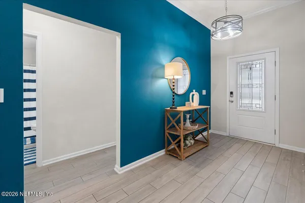 a view of a room with furniture and wooden floor