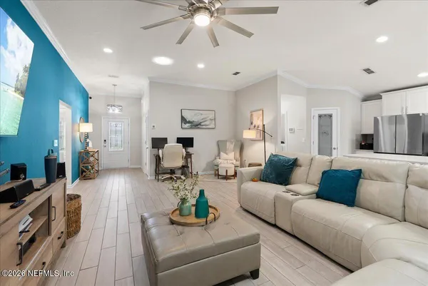 a living room with furniture and a chandelier