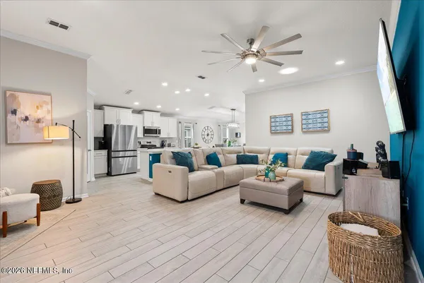 a living room with furniture and kitchen view
