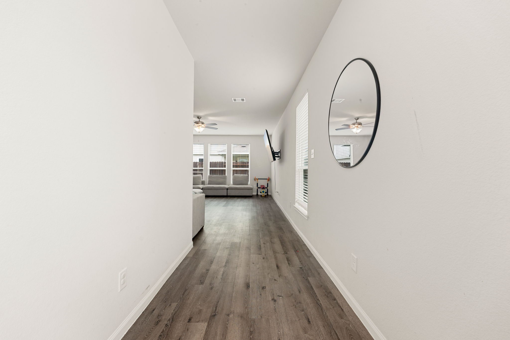 22210 Imperious Parkway Houston, TX 77073 - Photo 7 of 23 a view of a hallway with wooden floor and a fireplace