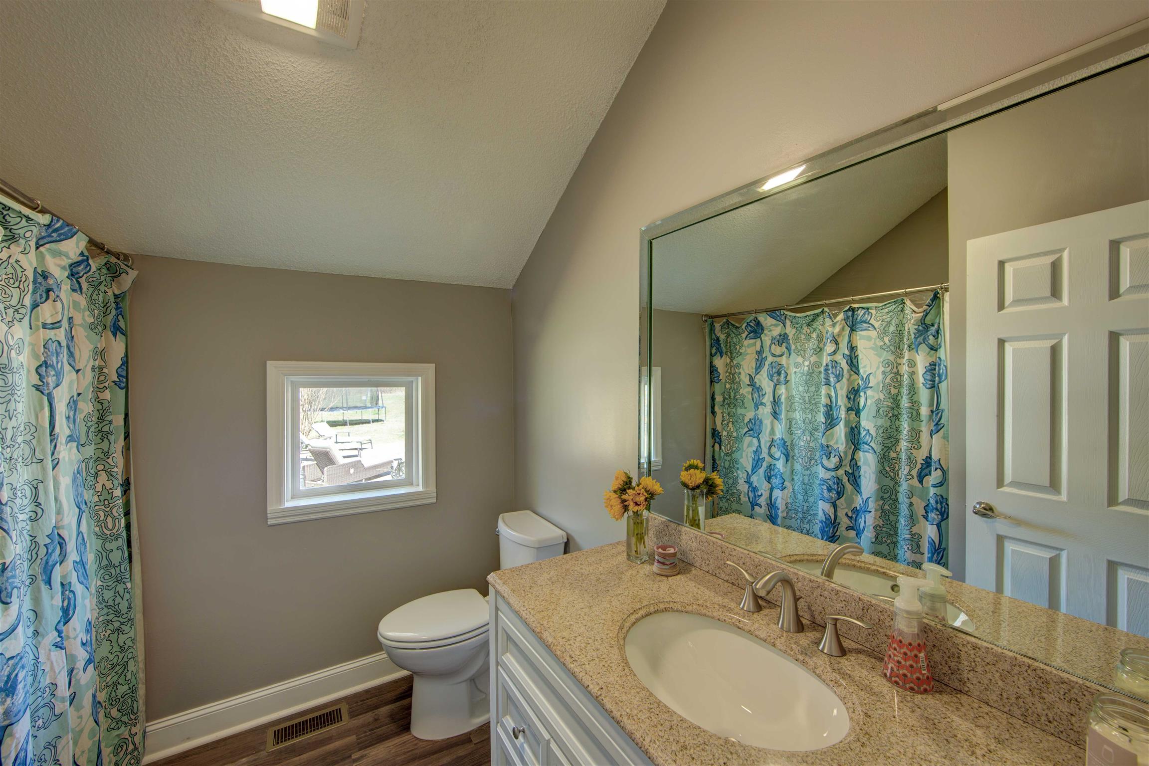700 Baker Road Columbia, TN 38401 - Photo 19 of 30 a bathroom with a granite countertop sink toilet and a mirror
