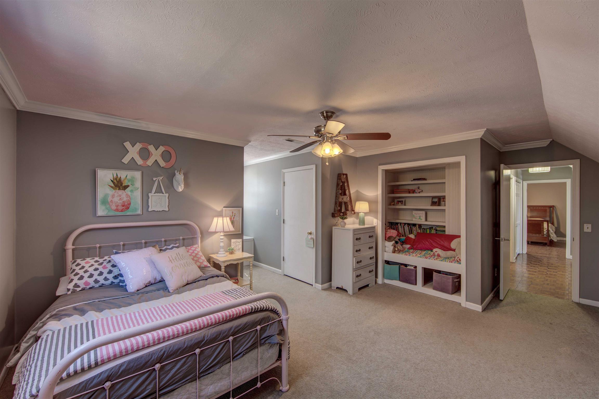 700 Baker Road Columbia, TN 38401 - Photo 23 of 30 a bedroom with a bed and a chandelier