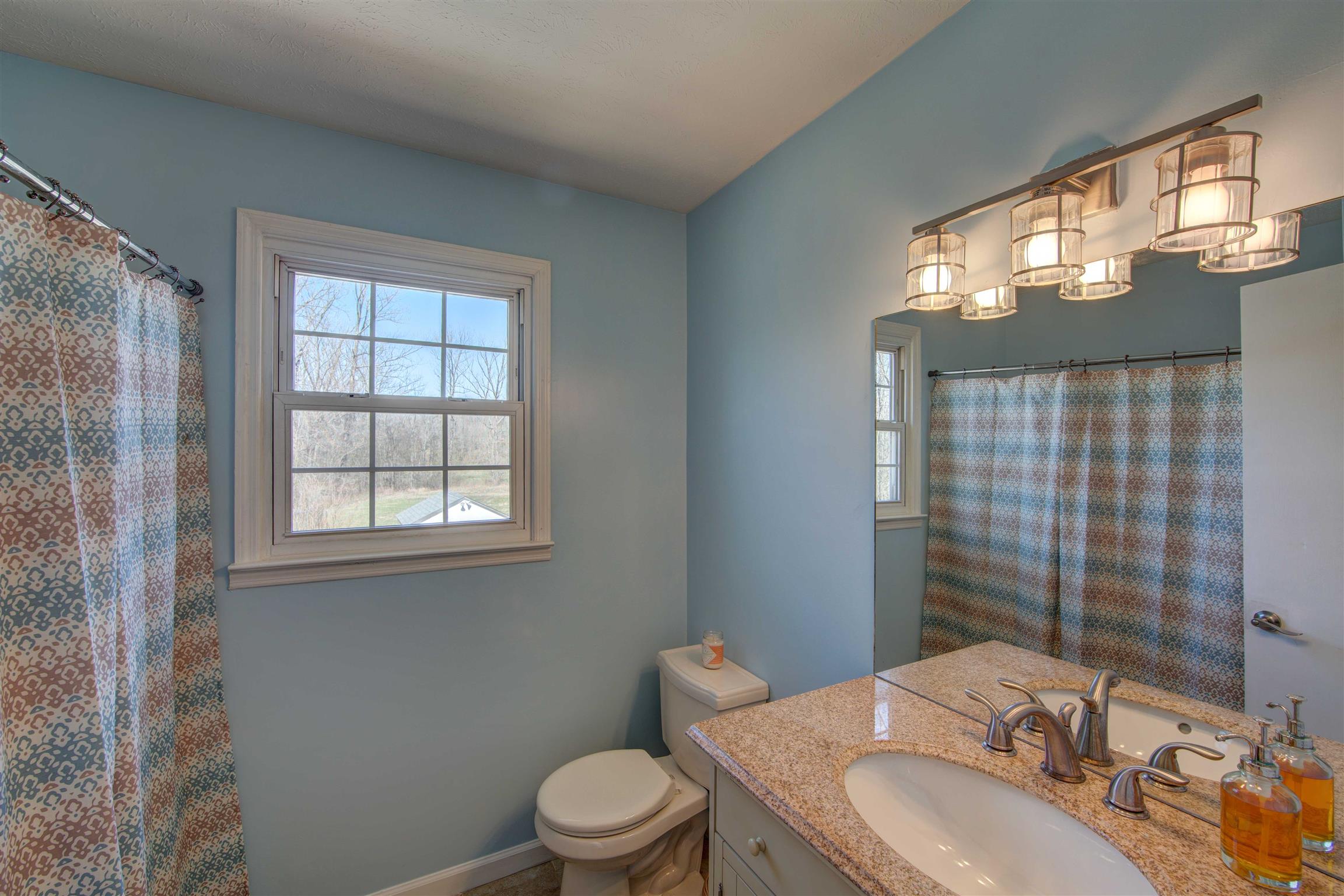 700 Baker Road Columbia, TN 38401 - Photo 24 of 30 a bathroom with a granite countertop sink toilet a mirror and shower