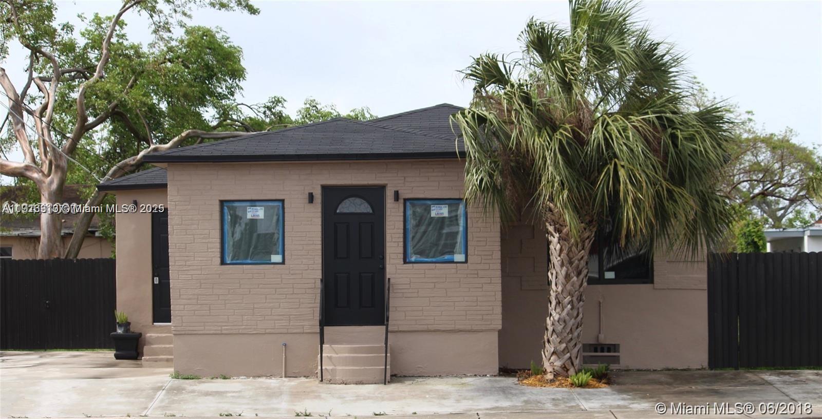 107 West Pembroke Road Hallandale Beach, FL 33009 - Photo 2 of 7 a front view of a house with a yard