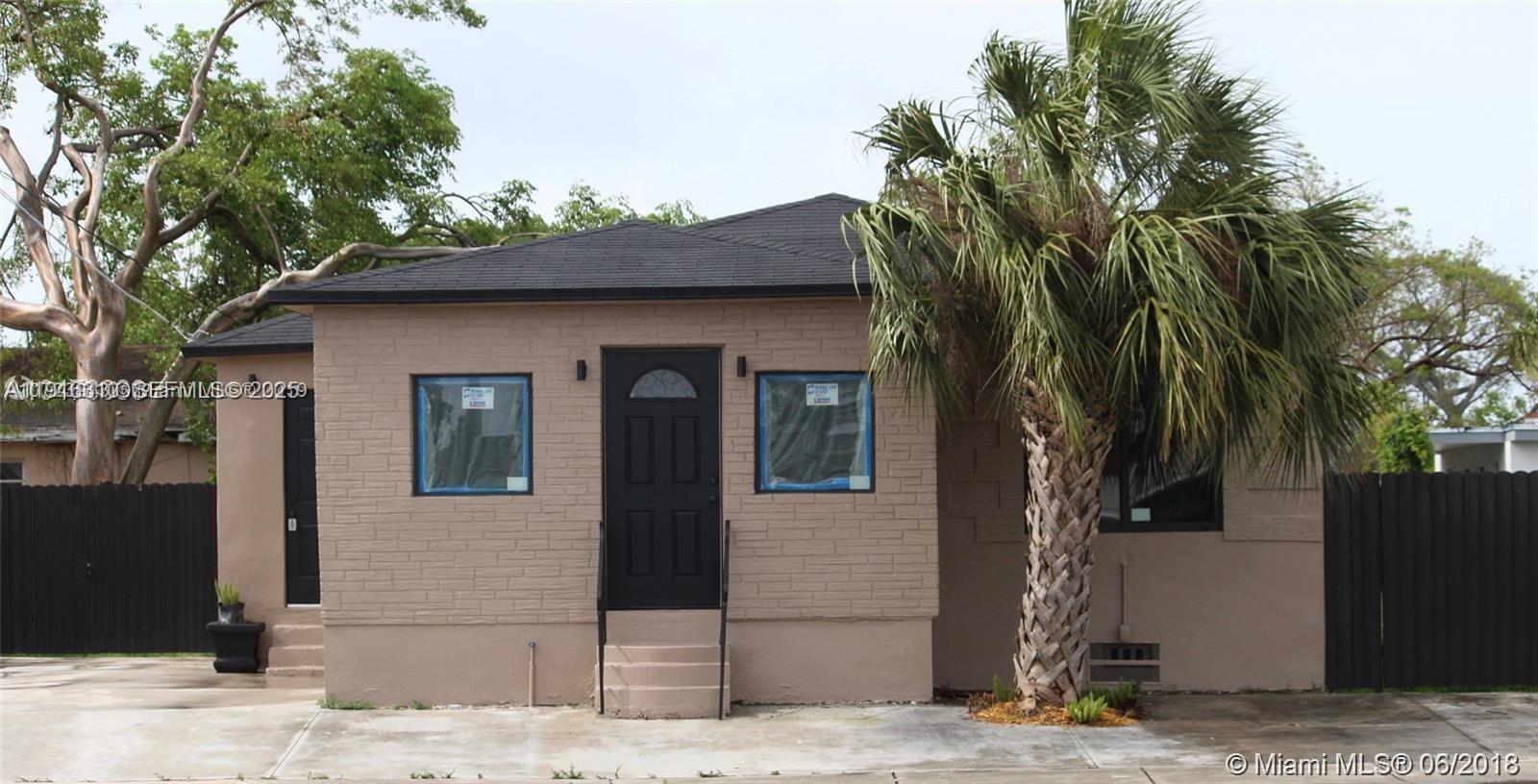 107 West Pembroke Road Hallandale Beach, FL 33009 - Photo 2 of 7 a front view of a house with a yard