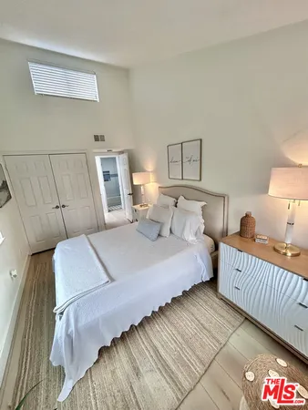 a bedroom with double bed and a night stand