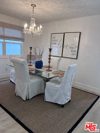 a living room with couches and a chandelier