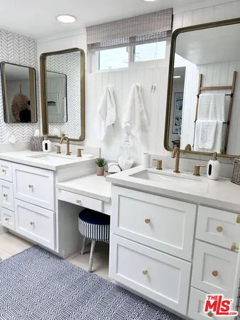 a bathroom with a double vanity sink mirror and
